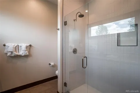 a bathroom with a toilet a sink a mirror and bathtub
