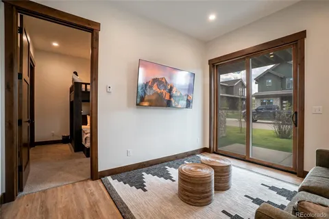 a living room with furniture and a floor to ceiling window
