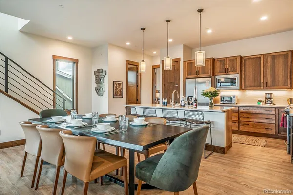 a dining table with chairs and kitchen view