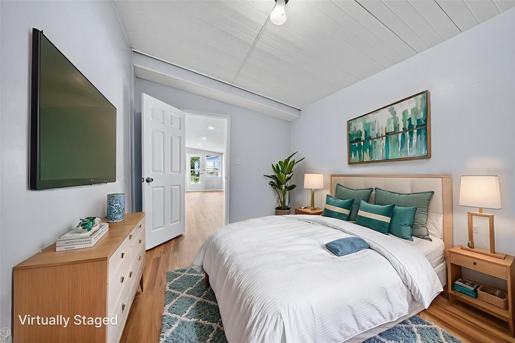 5162 Boca Raton Avenue Sarasota, FL 34234 - Photo 11 of 42 a bedroom with a bed and a flat screen tv