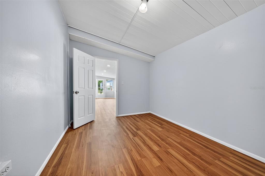 5162 Boca Raton Avenue Sarasota, FL 34234 - Photo 12 of 42 a view of a hallway with wooden floor
