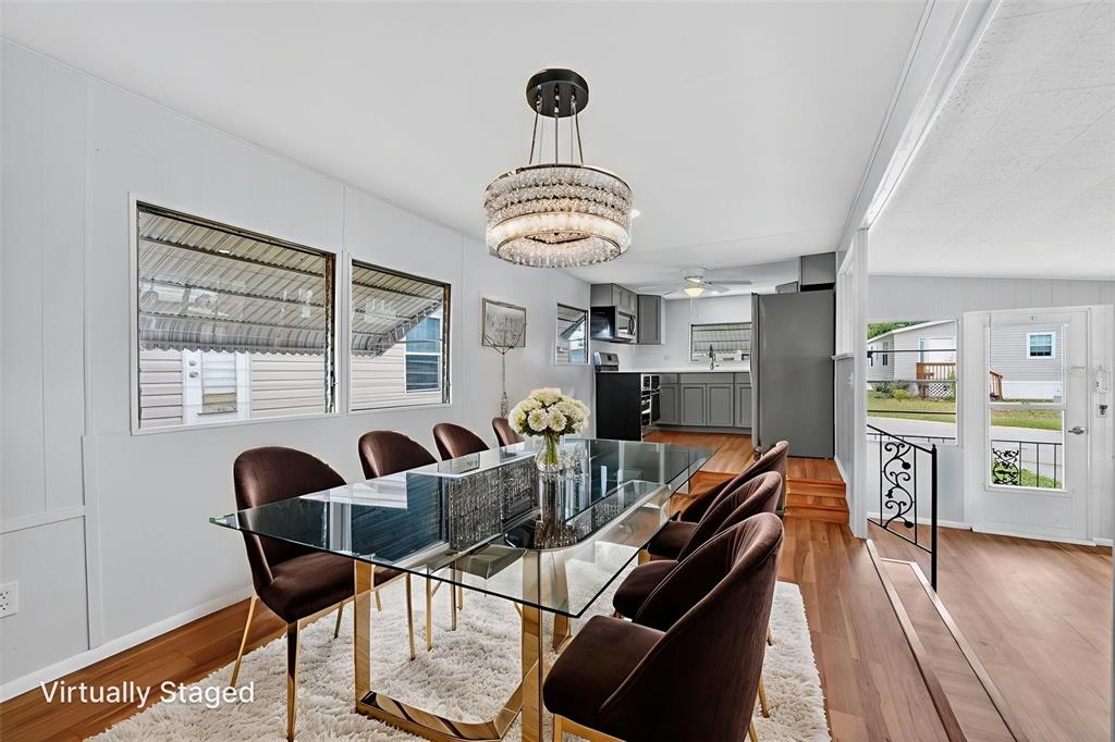 5162 Boca Raton Avenue Sarasota, FL 34234 - Photo 15 of 42 a view of a dining room with furniture and wooden floor