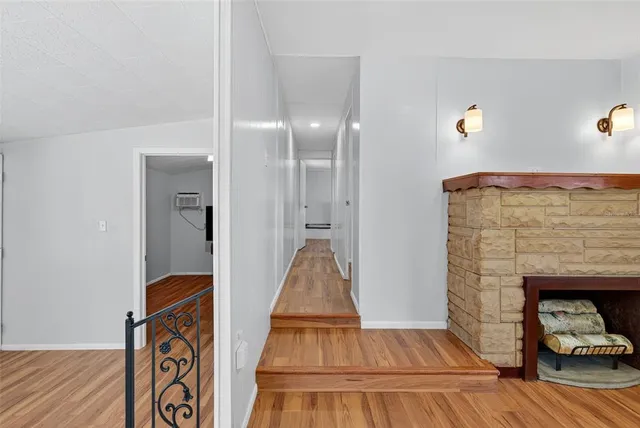 a view of room with wooden floor and ceiling fan