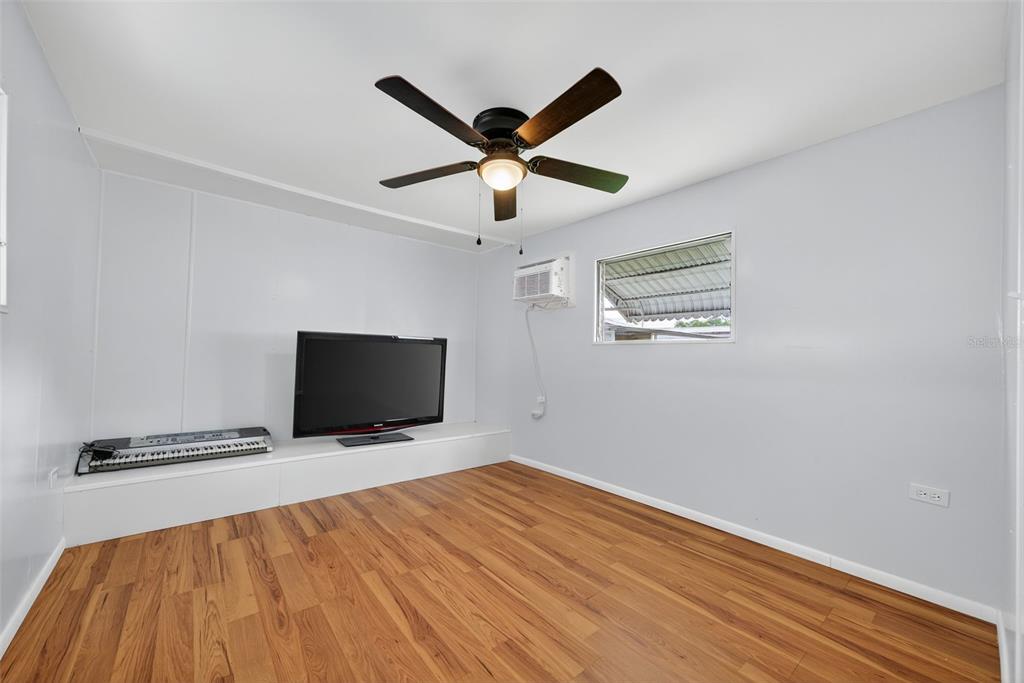 5162 Boca Raton Avenue Sarasota, FL 34234 - Photo 21 of 42 a view of room with wooden floor and ceiling fan