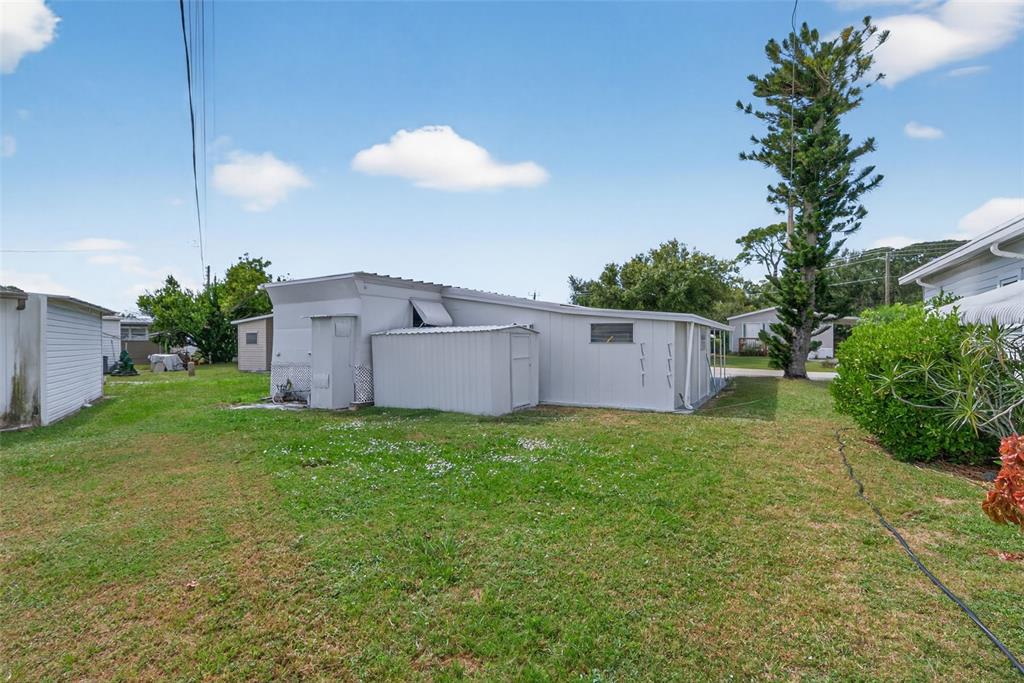 5162 Boca Raton Avenue Sarasota, FL 34234 - Photo 25 of 42 a backyard of a house with plants and outdoor seating
