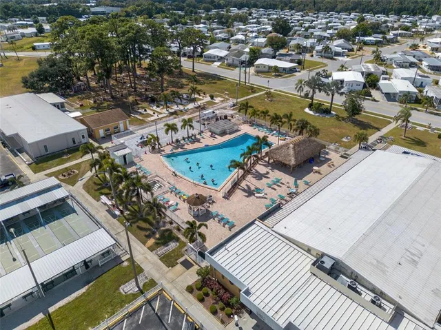 a row of palm trees in front of a house