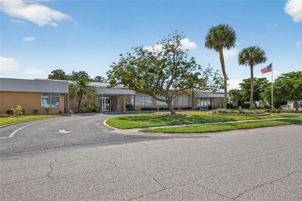 5162 Boca Raton Avenue Sarasota, FL 34234 - Photo 31 of 42 a view of a house with a yard and palm trees