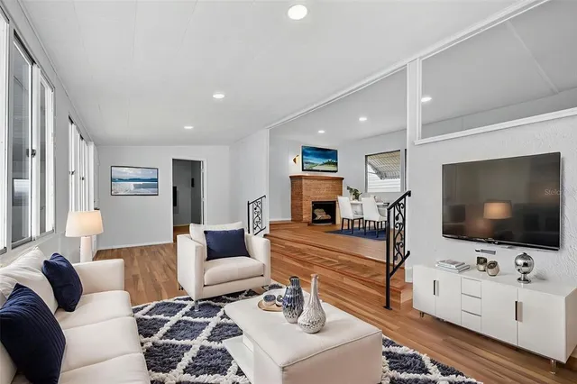 a view of empty room with wooden floor and fireplace