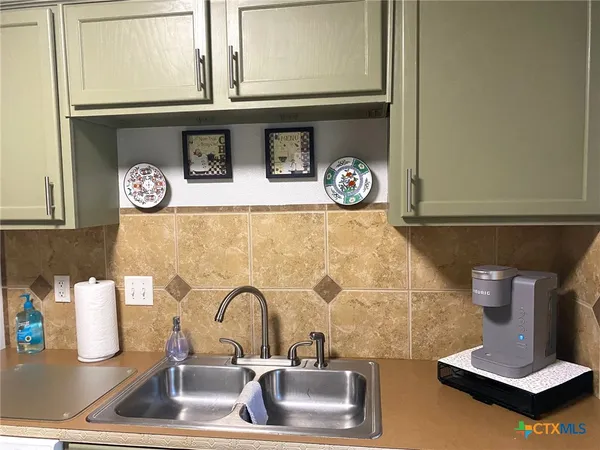 a kitchen with a stove and a white refrigerator