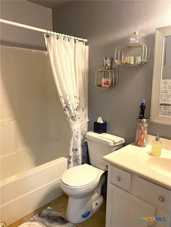 a bed sitting in a bedroom and painting on the wall