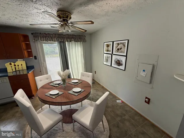 a dining room with furniture and window