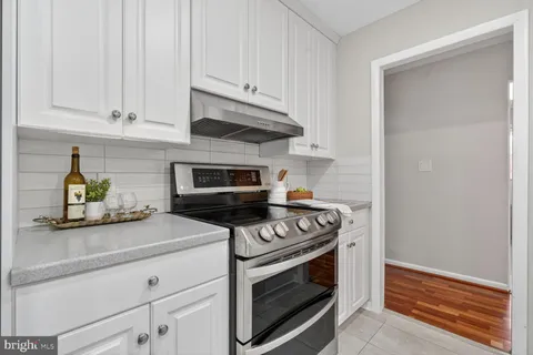 a kitchen with a sink window and cabinets