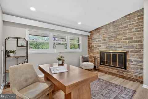 a living room with furniture a window and a fireplace