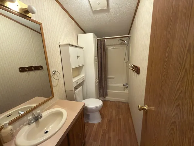 a bathroom with a sink toilet and shower