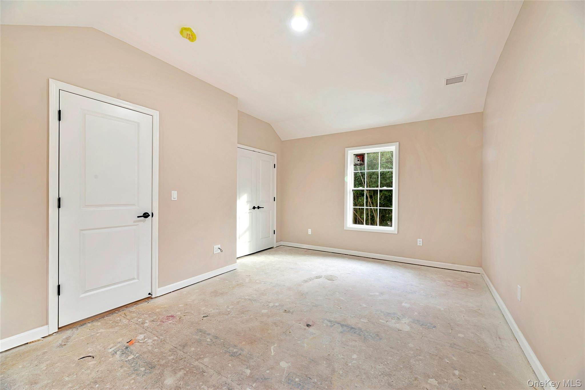 487 Neighborhood Road Shirley, NY 11967 - Photo 10 of 18 Unfurnished bedroom featuring baseboards and vaulted ceiling