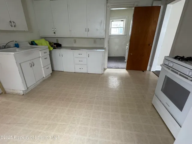 a kitchen with cabinets and white appliances