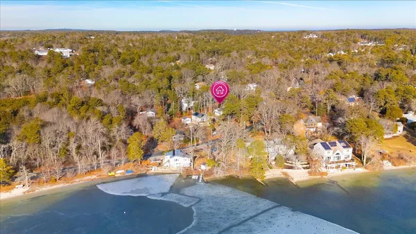 a kitchen with granite countertop white cabinets white appliances with a sink and dishwasher