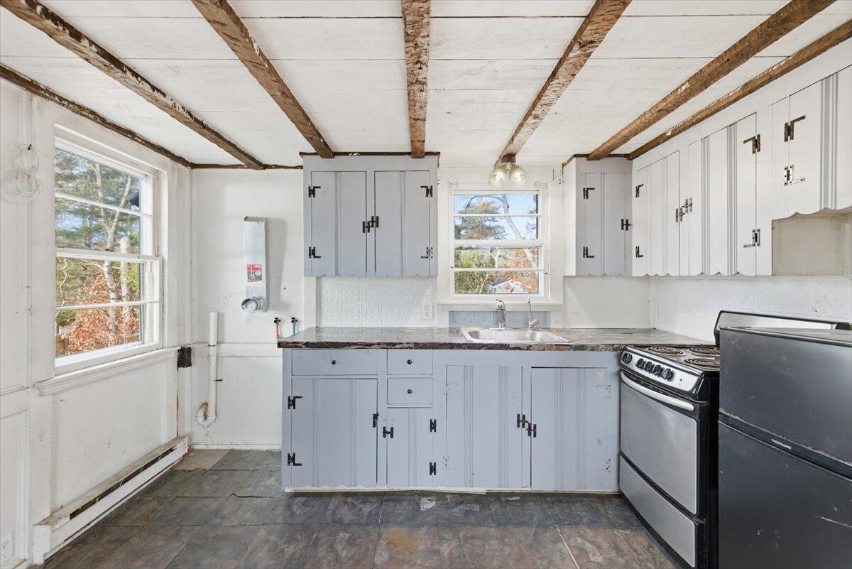 53 Carter's Bridge Road Plymouth, MA 02360 - Photo 4 of 30 a kitchen with granite countertop white cabinets white appliances with a sink and dishwasher