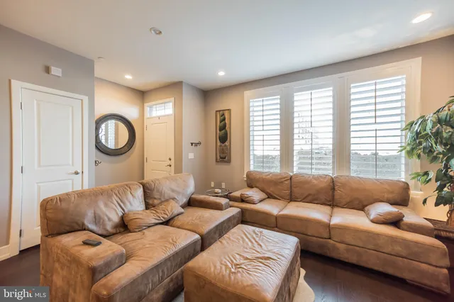 a living room with furniture a large window and a couch