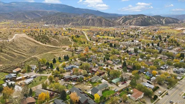 an aerial view of a house with a yard