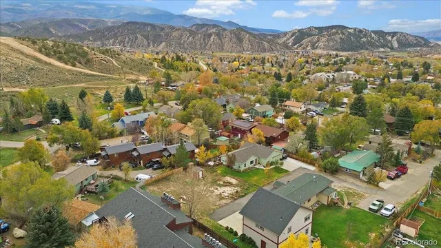 an aerial view of a house with swimming pool and porch