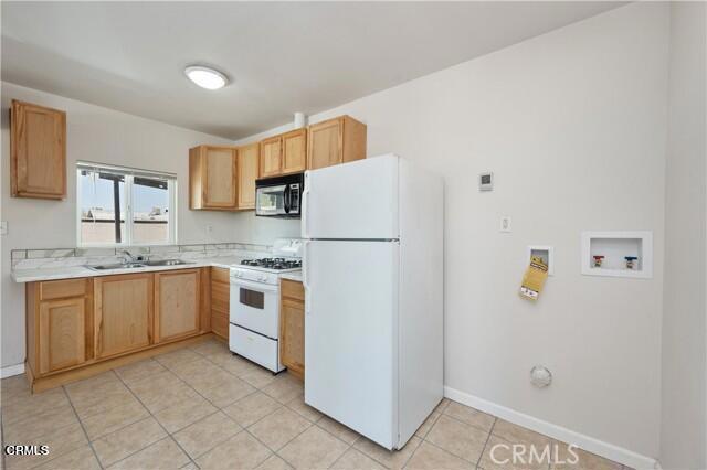 45027 Division Street Lancaster, CA 93535 - Photo 2 of 11 a kitchen with stainless steel appliances granite countertop a refrigerator and a sink