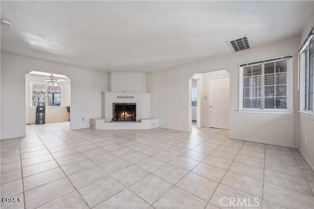 45027 Division Street Lancaster, CA 93535 - Photo 4 of 11 an empty room with windows and fireplace