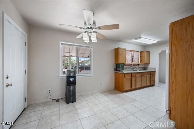 45027 Division Street Lancaster, CA 93535 - Photo 5 of 11 a kitchen with stainless steel appliances granite countertop a refrigerator and a sink