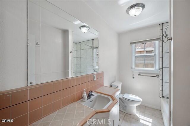 45027 Division Street Lancaster, CA 93535 - Photo 6 of 11 a bathroom with a toilet a sink and mirror