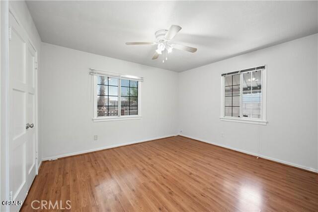 45027 Division Street Lancaster, CA 93535 - Photo 7 of 11 a view of an empty room with wooden floor and a window