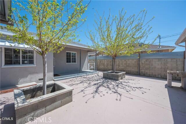 45027 Division Street Lancaster, CA 93535 - Photo 10 of 11 a view of a backyard with table and chairs and wooden fence