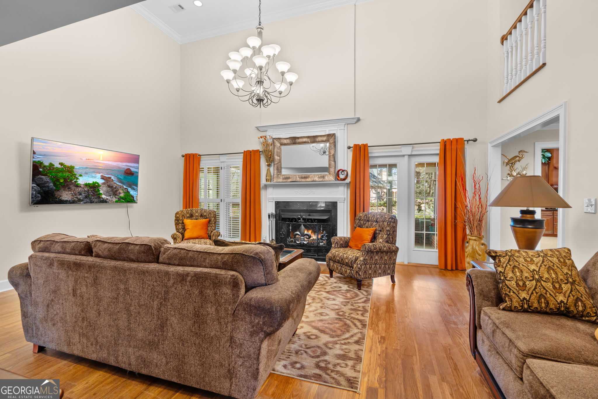 109 Crest Pointe Warner Robins, GA 31088 - Photo 12 of 86 a living room with furniture a chandelier and a flat screen tv
