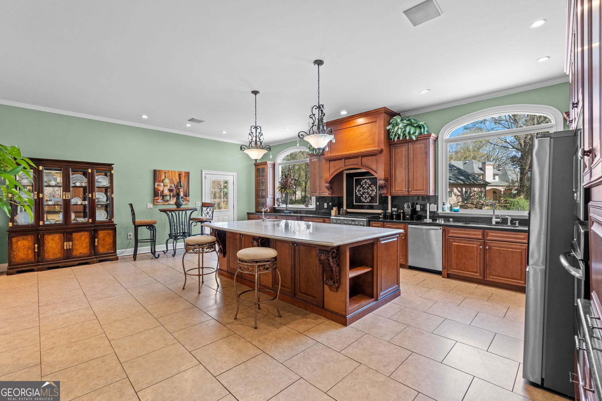 109 Crest Pointe Warner Robins, GA 31088 - Photo 20 of 86 a kitchen with stainless steel appliances granite countertop a stove a sink a dining table and chairs
