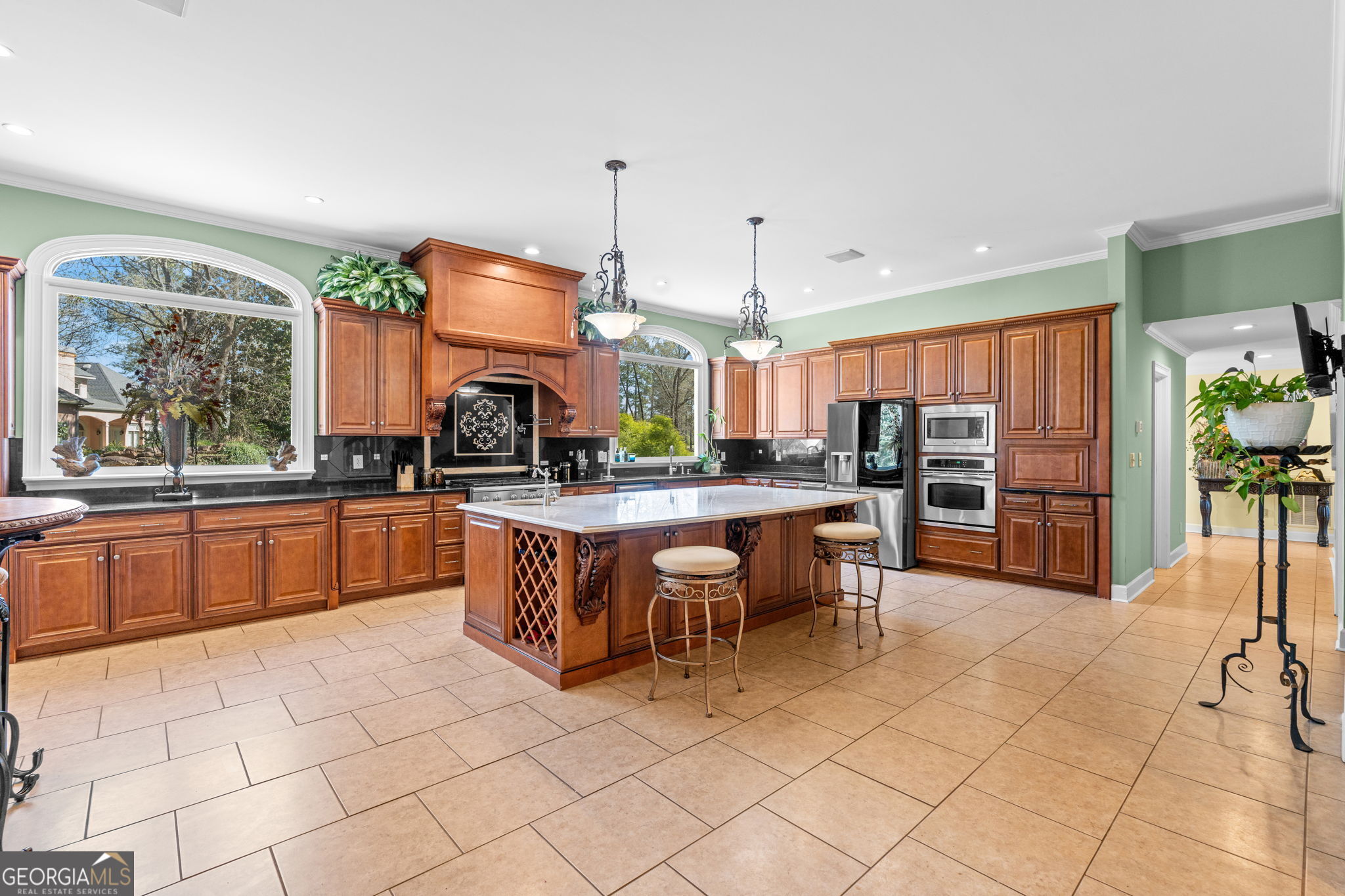 109 Crest Pointe Warner Robins, GA 31088 - Photo 21 of 86 a kitchen with stainless steel appliances kitchen island granite countertop a stove a sink a dining table and chairs