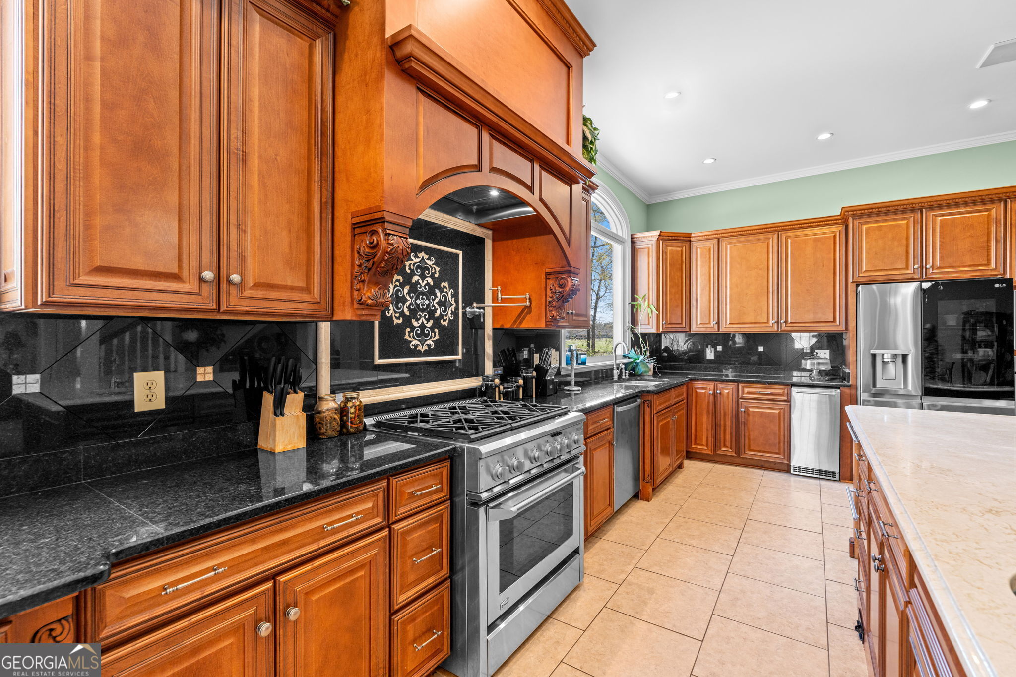 109 Crest Pointe Warner Robins, GA 31088 - Photo 23 of 86 a kitchen with stainless steel appliances granite countertop a stove a sink and a microwave