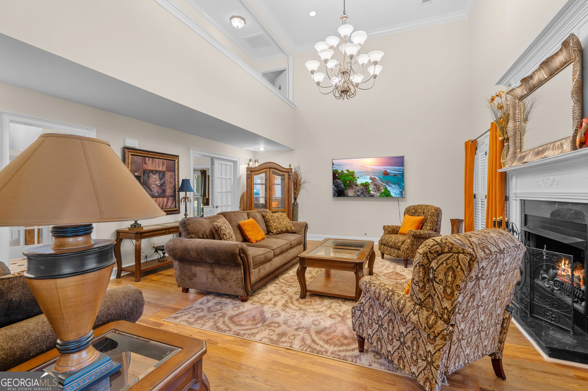 109 Crest Pointe Warner Robins, GA 31088 - Photo 9 of 86 a living room with furniture a chandelier and a flat screen tv