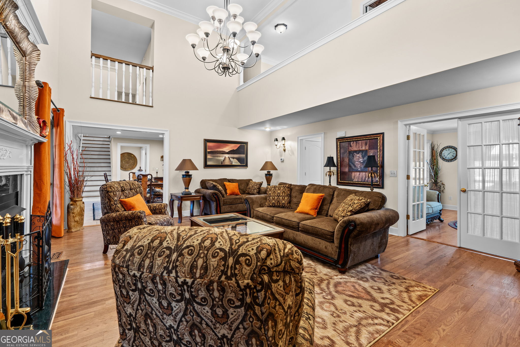 109 Crest Pointe Warner Robins, GA 31088 - Photo 10 of 86 a living room with furniture a chandelier and a flat screen tv