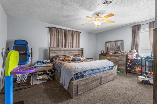 a bedroom with bed and a chandelier