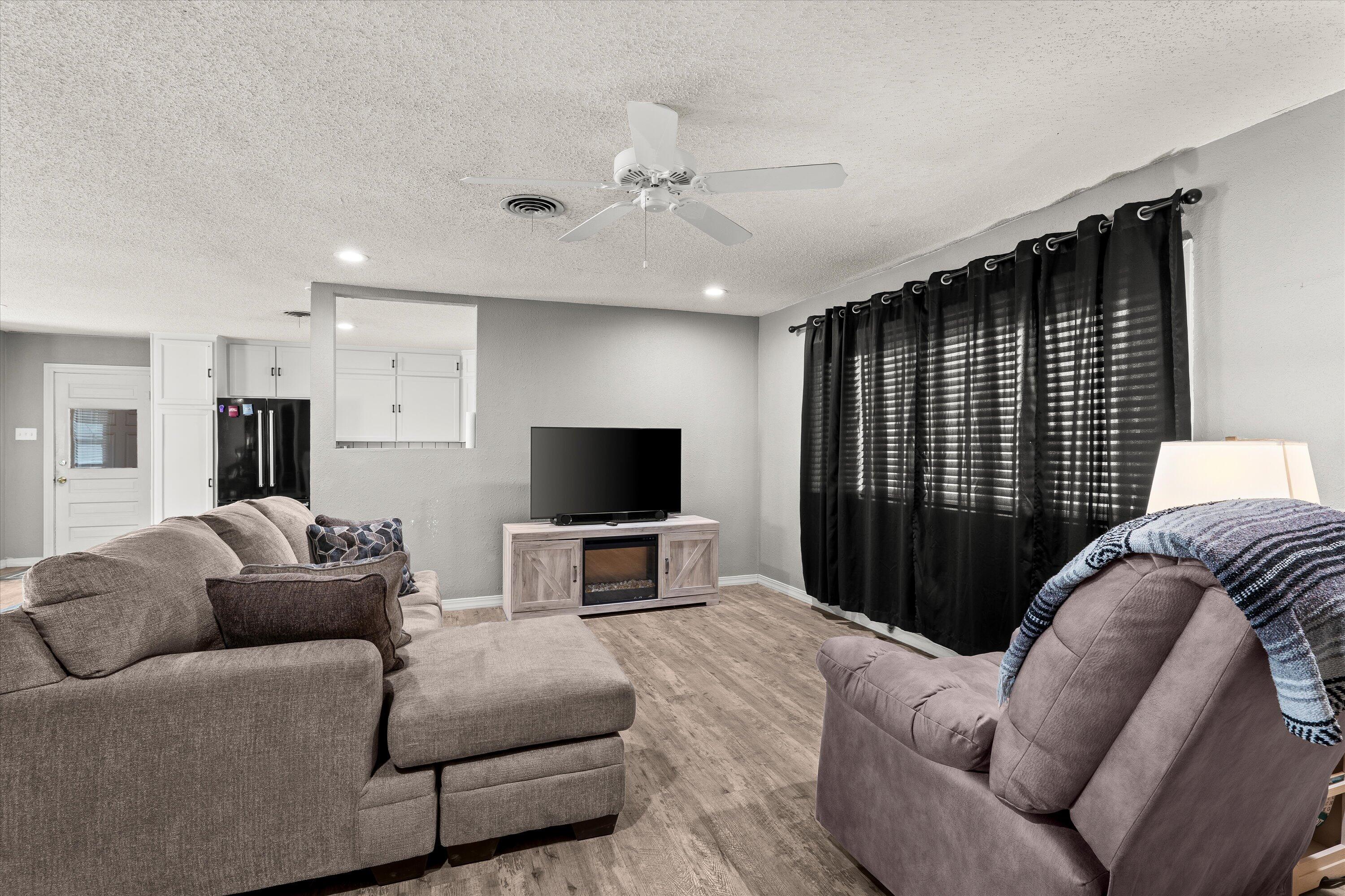102 3rd Street Plains, TX 79355 - Photo 21 of 29 a living room with furniture and a flat screen tv