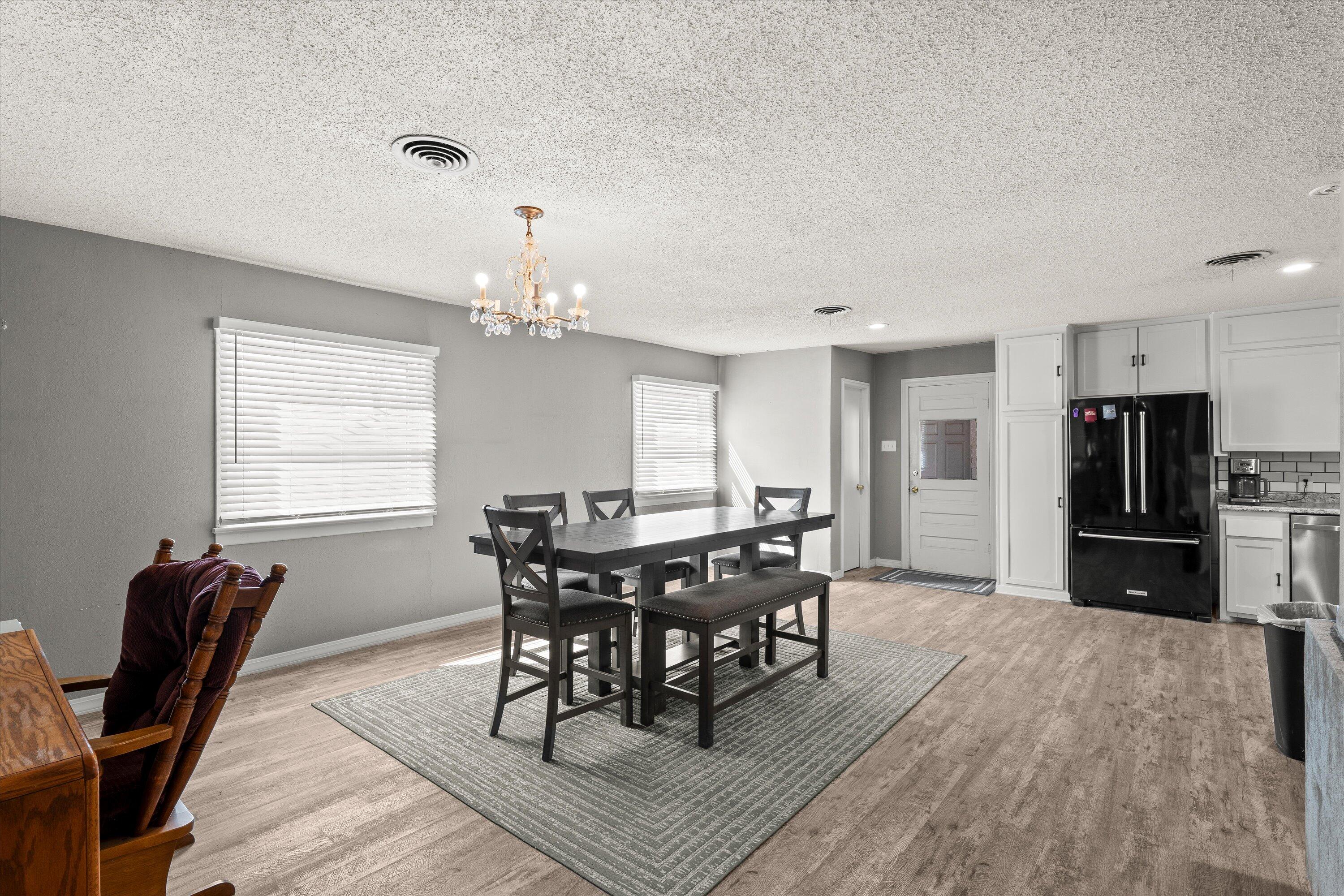 102 3rd Street Plains, TX 79355 - Photo 25 of 29 a view of a dining room with furniture and wooden floor