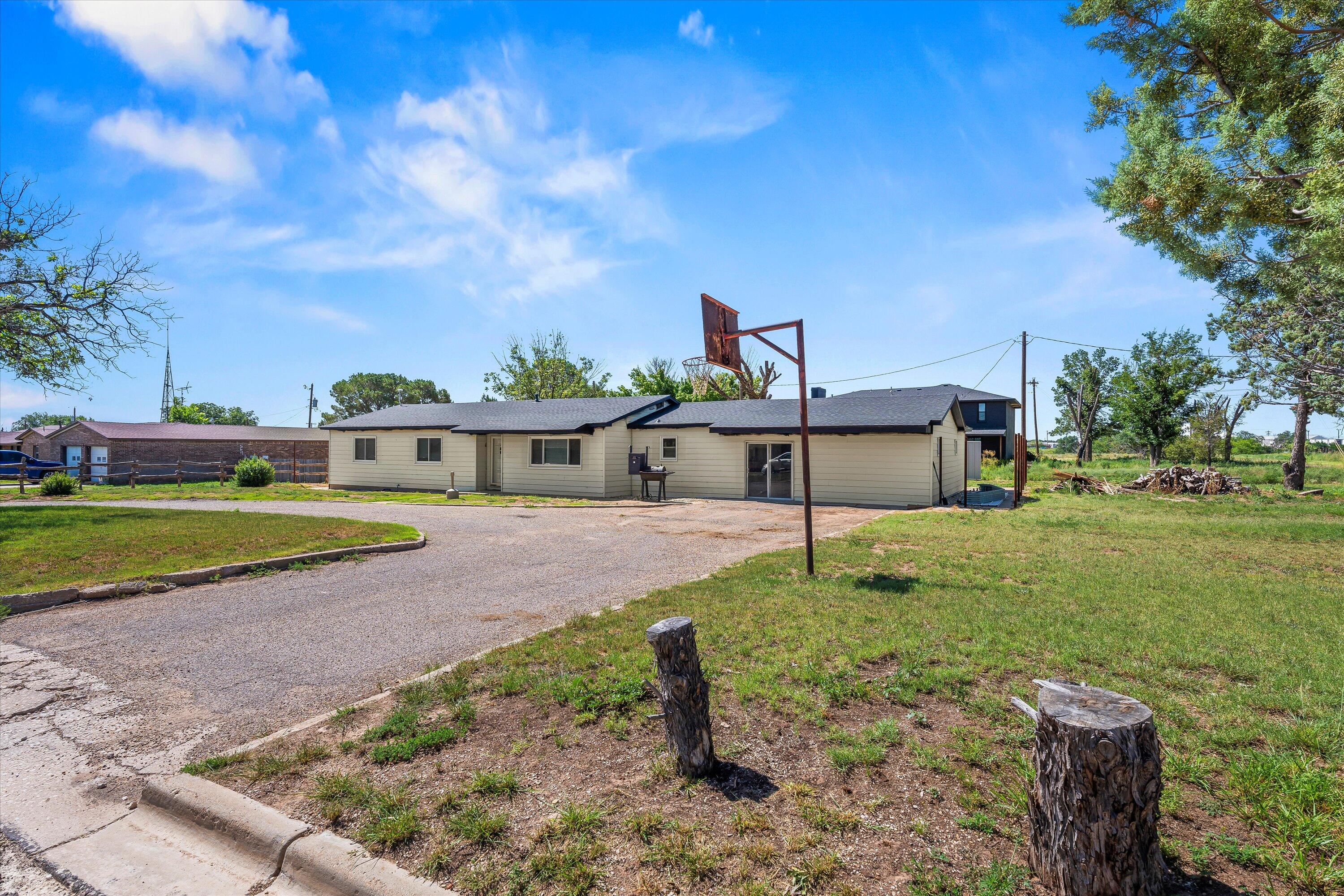102 3rd Street Plains, TX 79355 - Photo 3 of 29 a view of a house with a yard