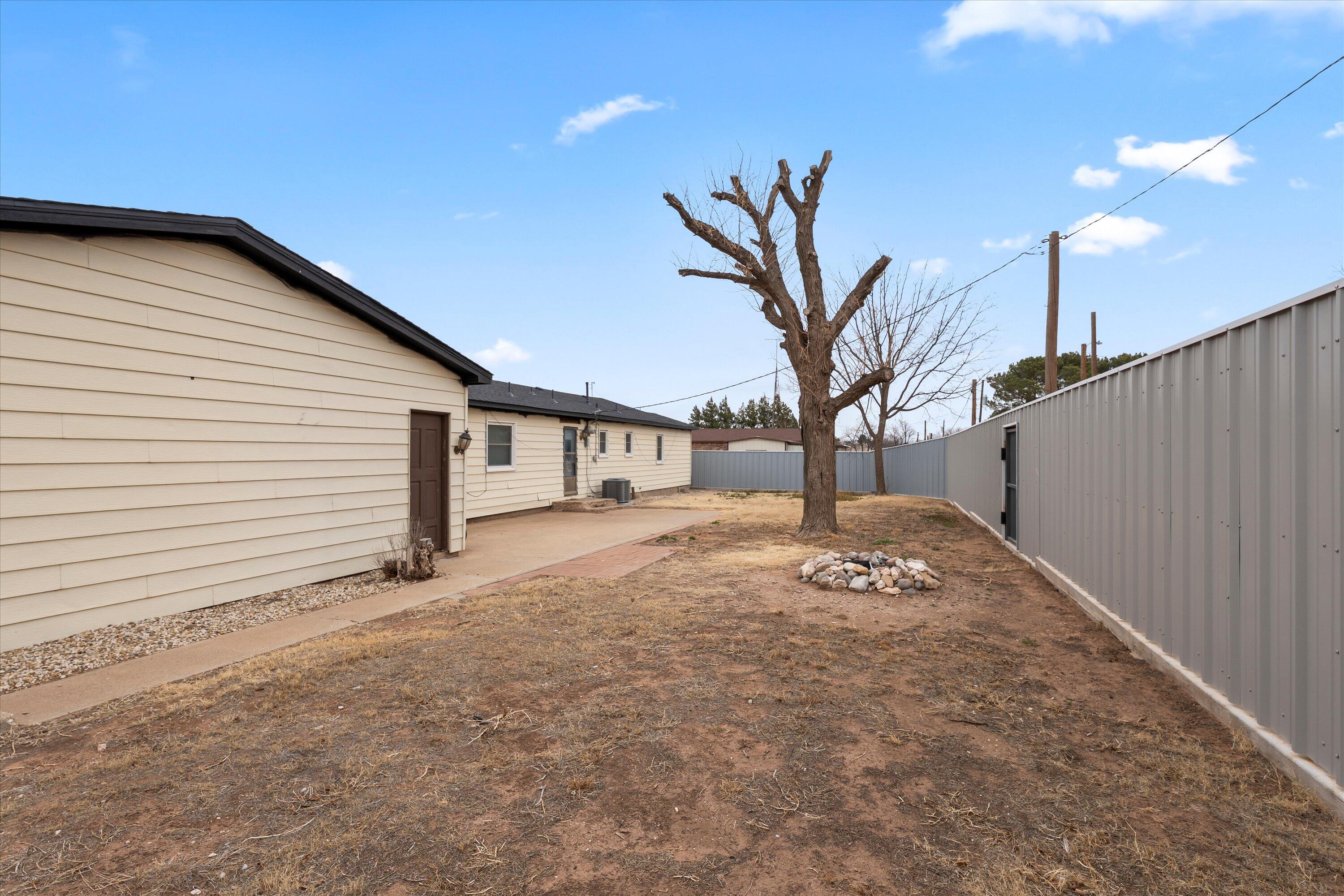 102 3rd Street Plains, TX 79355 - Photo 4 of 29 a view of a house with a yard