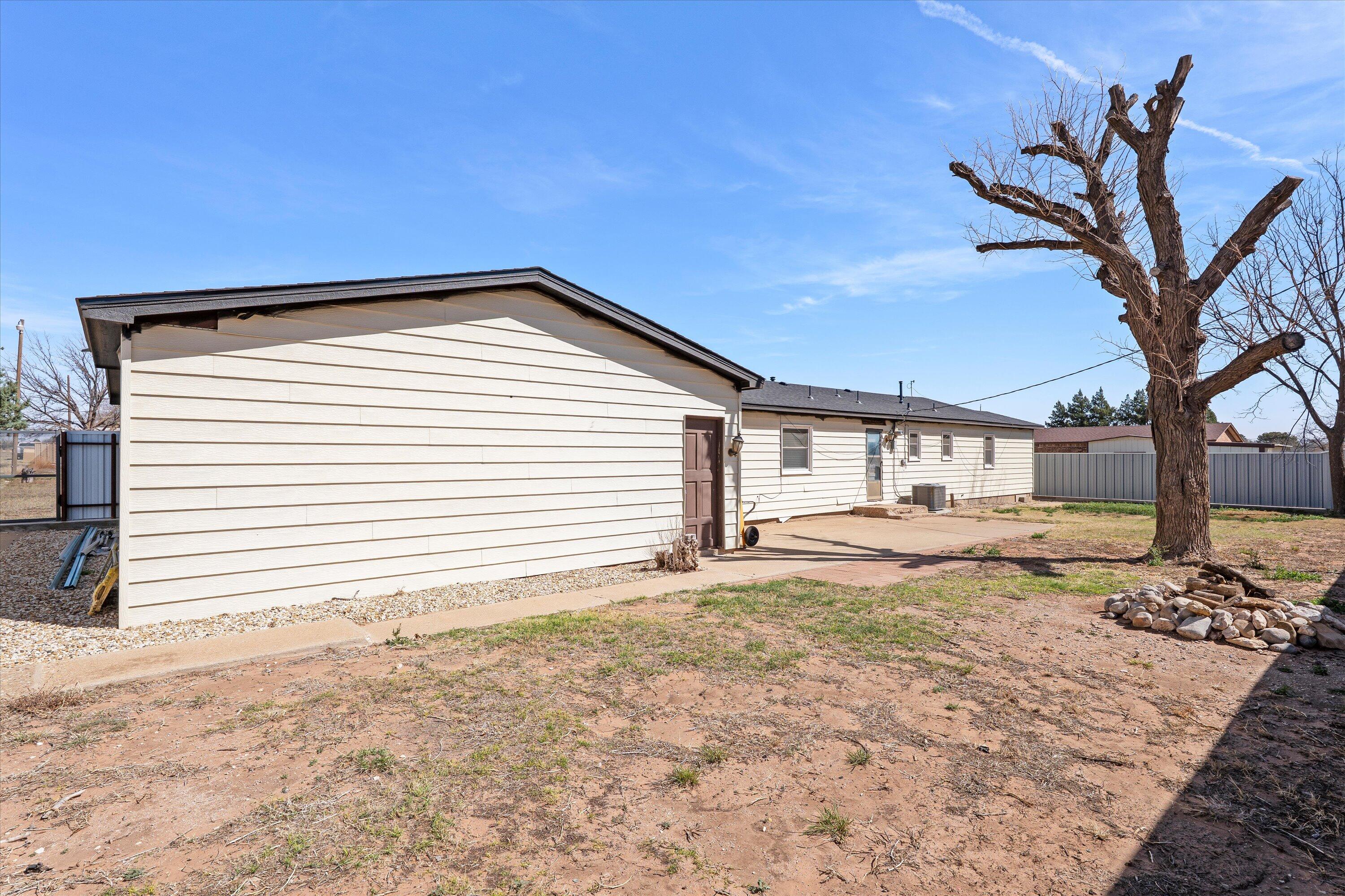 102 3rd Street Plains, TX 79355 - Photo 6 of 29 a view of a house with a backyard