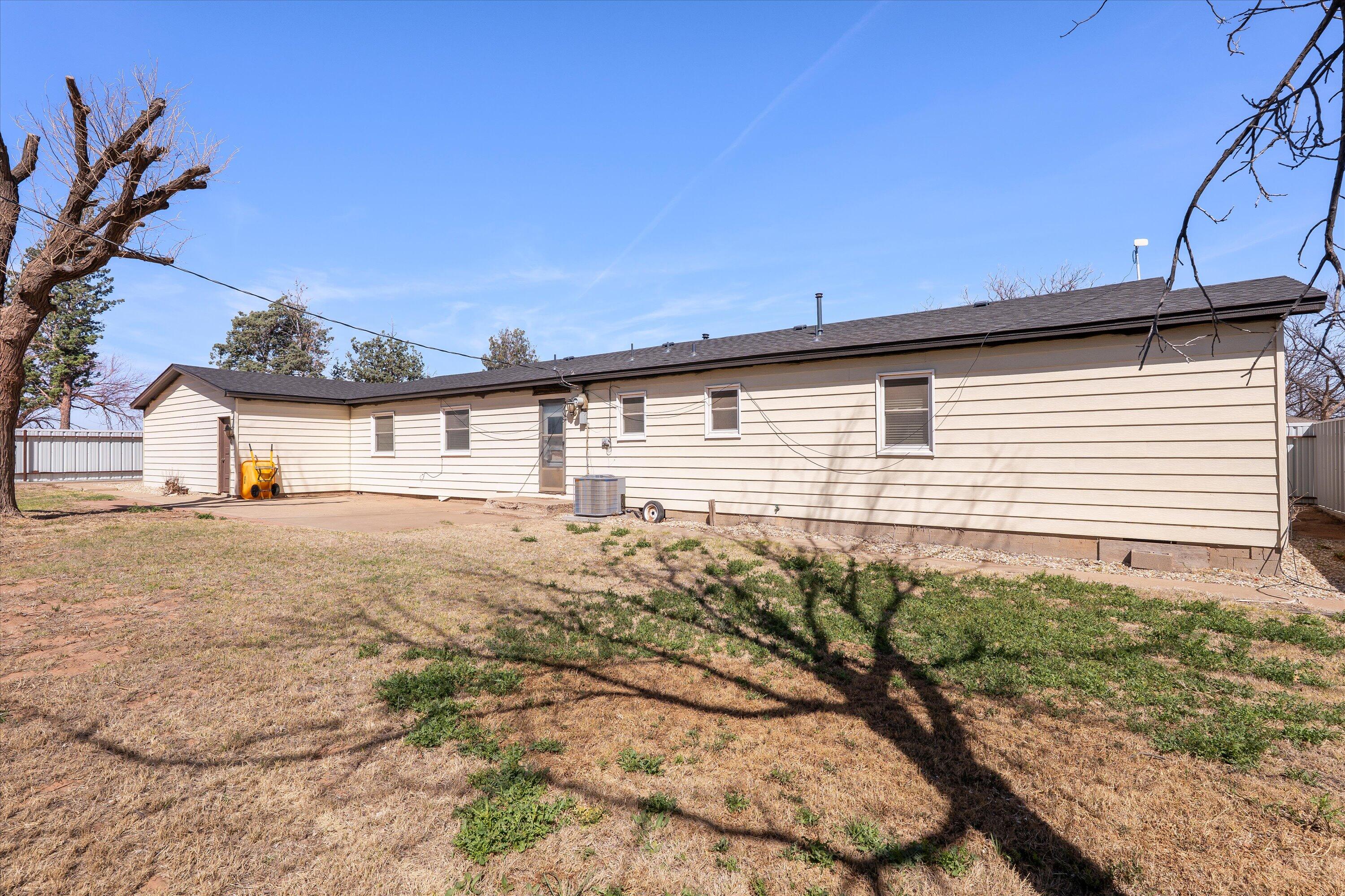 102 3rd Street Plains, TX 79355 - Photo 7 of 29 a view of a house with a backyard