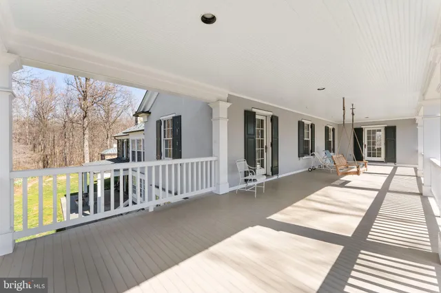 a view of a livingroom with wooden floor a fireplace and windows