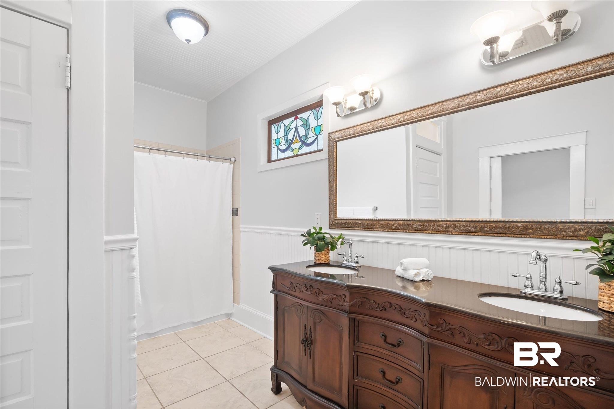 14 South Monterey Street Mobile, AL 36604 - Photo 13 of 41 Bathroom with vanity, tile patterned floors, and a shower with shower curtain