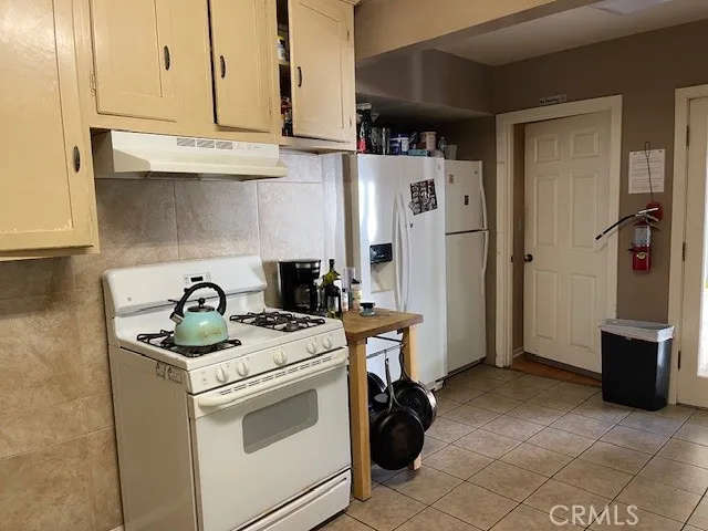 a kitchen with a stove and a refrigerator