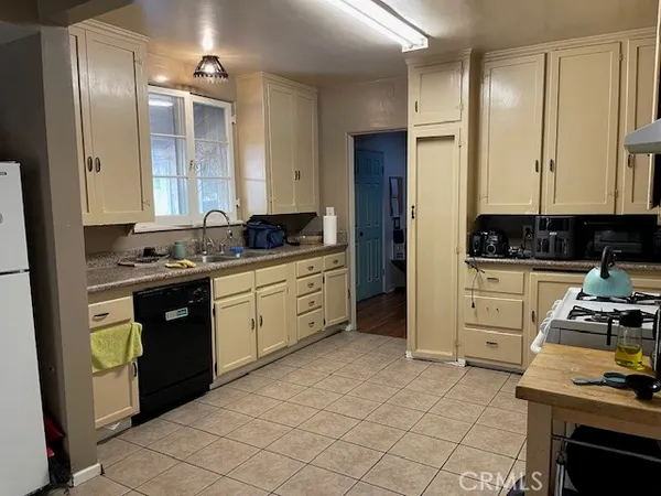 a kitchen with stainless steel appliances a stove a sink and a refrigerator
