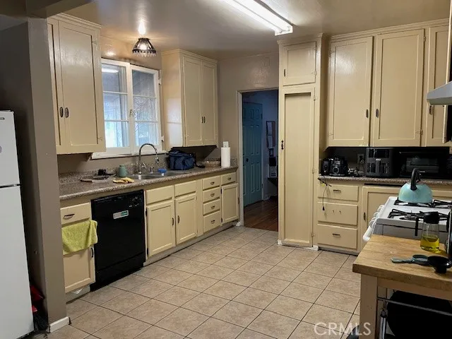 a kitchen with stainless steel appliances a stove a sink and a refrigerator