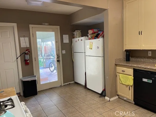 a white refrigerator freezer and a stove sitting inside of a kitchen